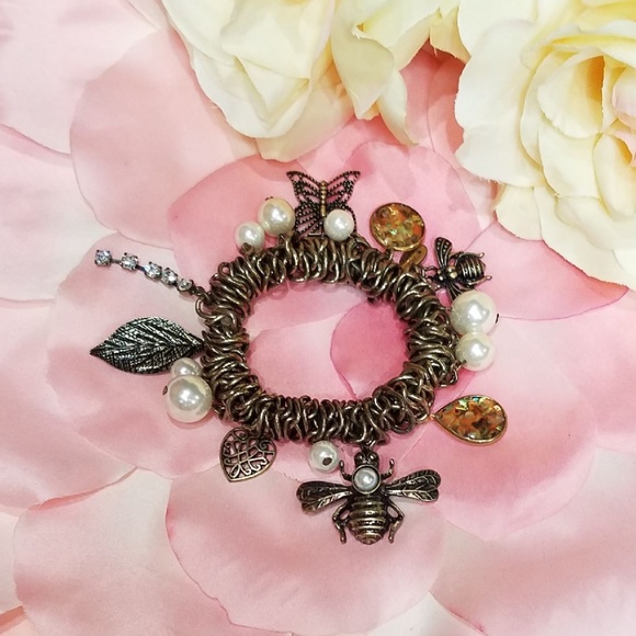 Jewelry - Antique gold toned bracelet with lots of charms.